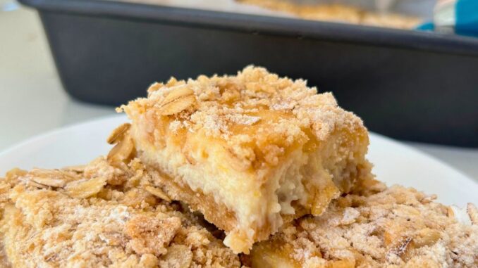 creamy lemon crumble bars arranged on a plate