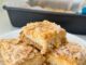 creamy lemon crumble bars arranged on a plate