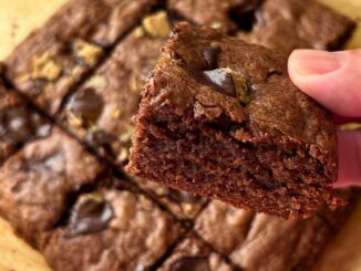 close up of a cut piece of chocolate brownie with chocolate sunflower butter cups