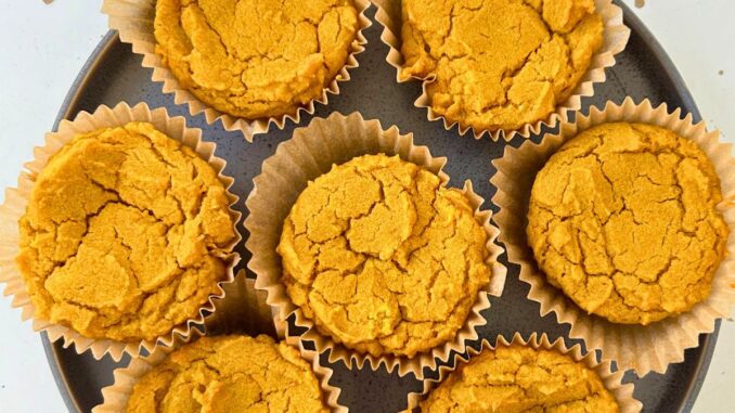 overhead photo of pumpkin mochi muffins arranged on a plate