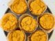 overhead photo of pumpkin mochi muffins arranged on a plate