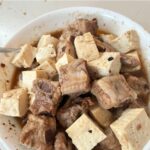 steamed spareribs with tofu in a white serving bowl