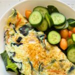 egg white omelet served with a small salad in a white salad plate