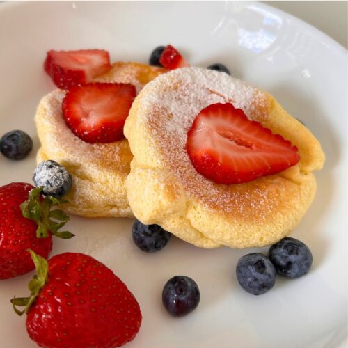 Japanese souffle pancakes served with strawberries and blueberries