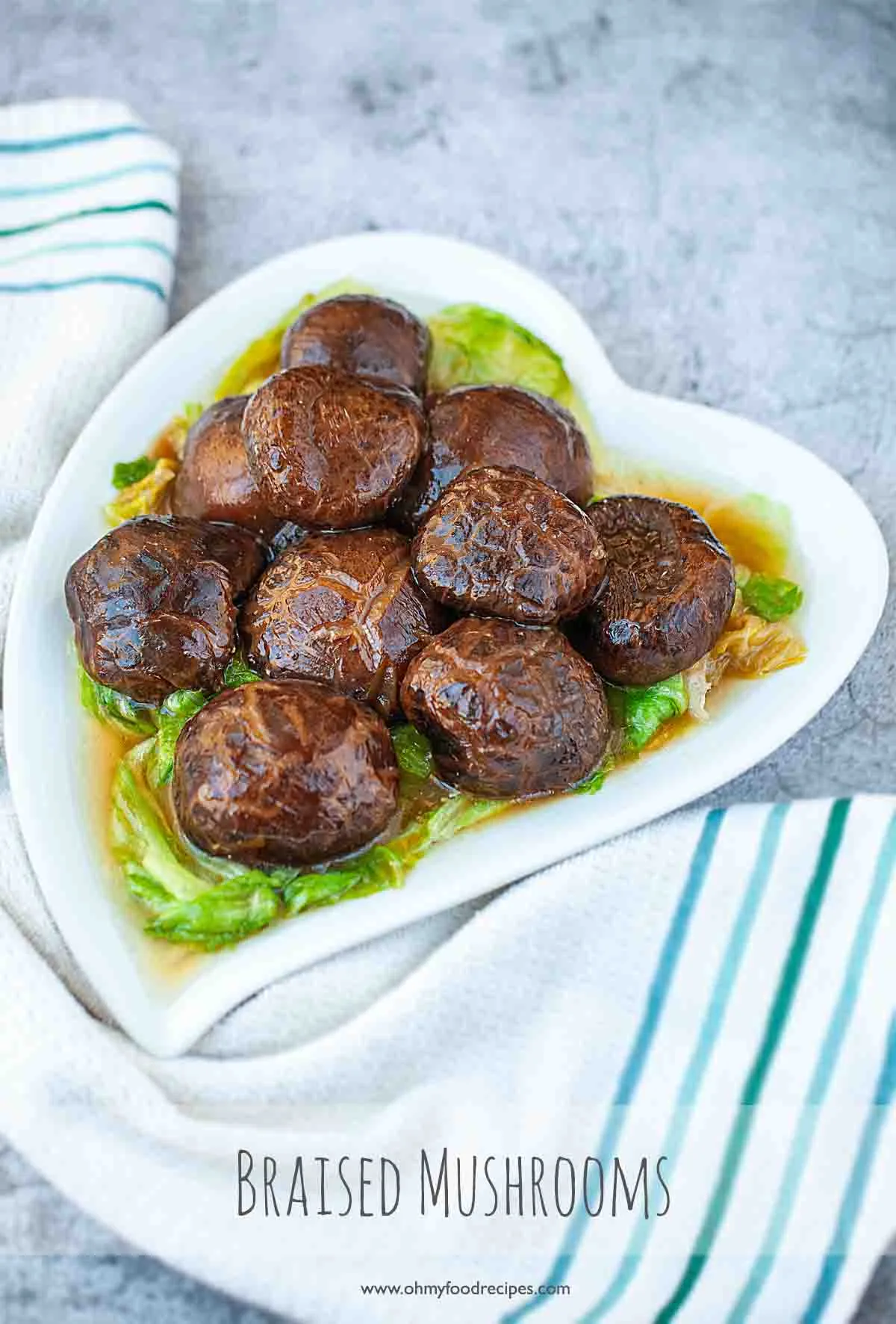 braised mushroom and lettuce served in a white heart shaped bowl