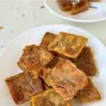 Pan fried nian gao on a round white plate