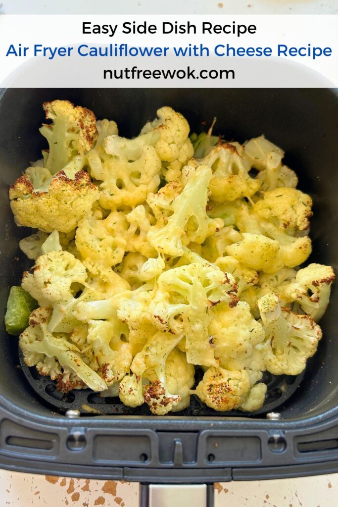 Cauliflower with melted cheese in an air fryer basket
