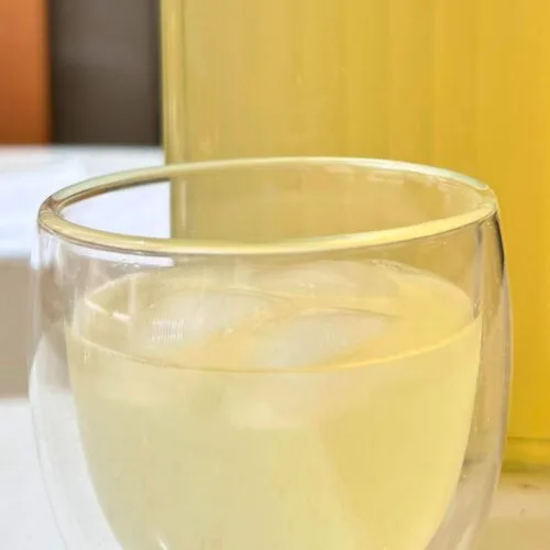 close up of Meyer lemon lemonade in a double walled glass