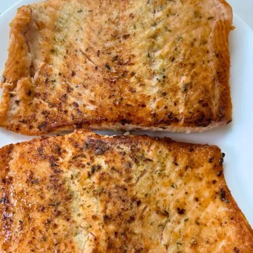 pan fried salmon on a white plate