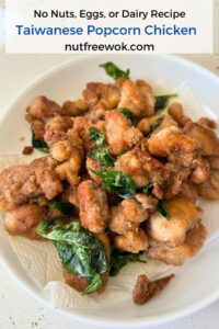 pan fried Taiwanese popcorn chicken with basil served in a paper towel lined white plate
