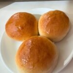 3 baked char siu baos on a cake plate