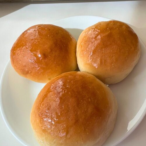 3 baked char siu baos on a cake plate