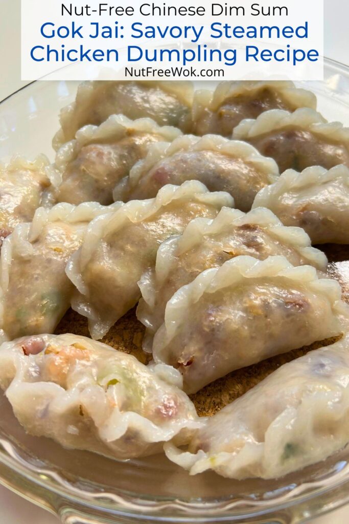 A plate of steamed chicken and vegetable gok jai, a Chinese steamed dim sum dumpling.
